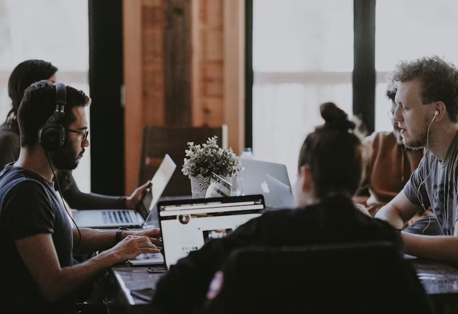 A team working together at their laptops